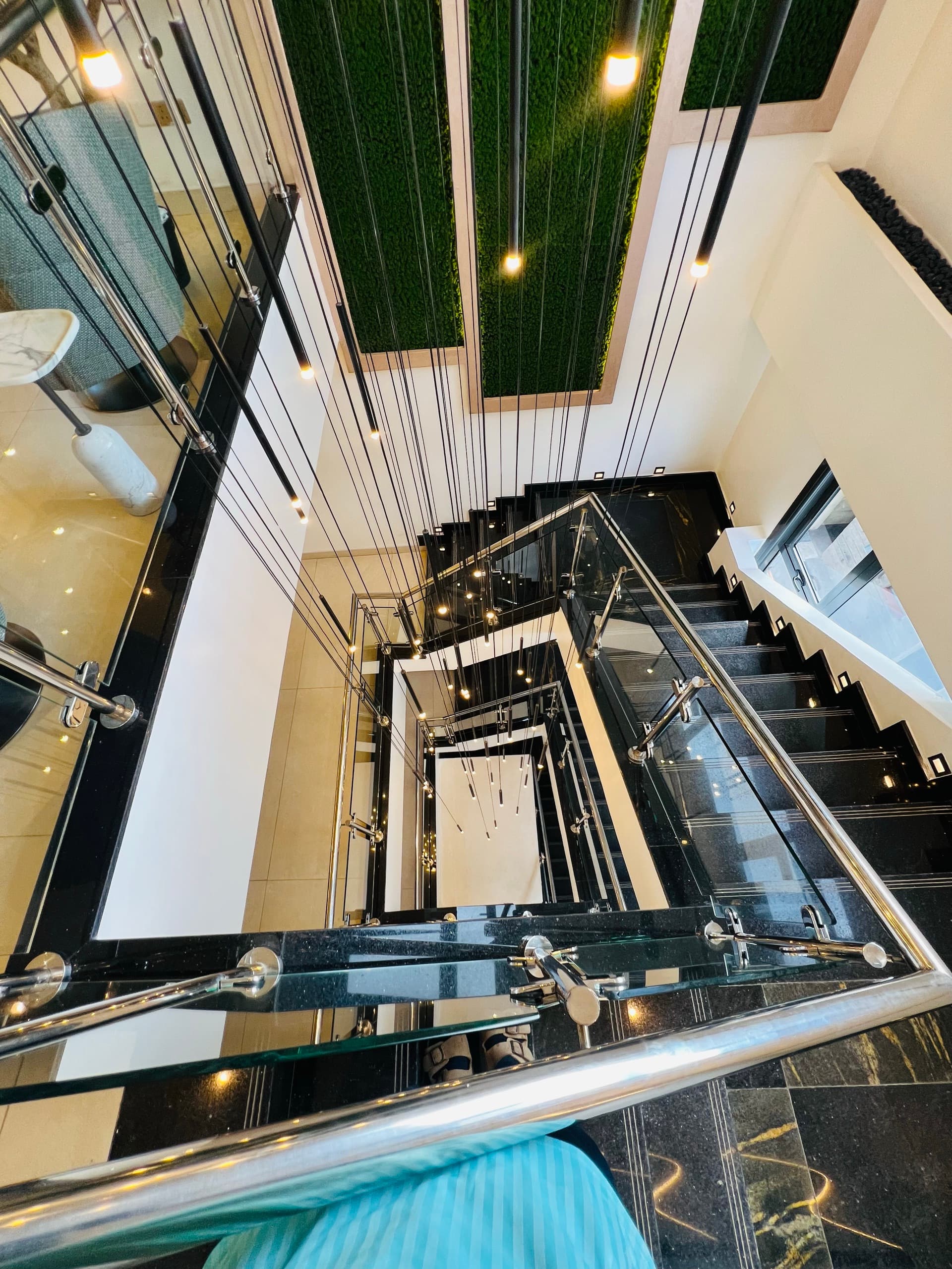Overhead view of the marble staircase — architectural geometry from above